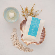 Load image into Gallery viewer, Packet of Island Aura wax melts on a scallop shell