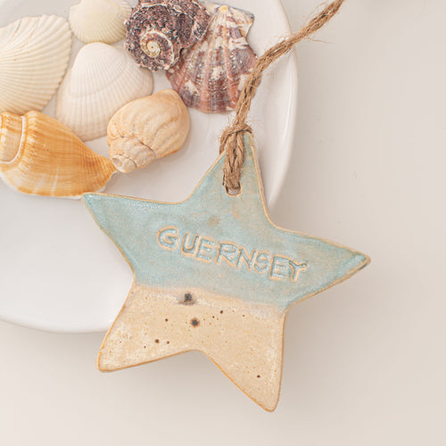 Island Aura hanging Guernsey ceramic star with a coastal glaze