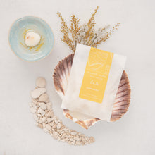 Load image into Gallery viewer, Packet of Island Aura wax melts on a scallop shell
